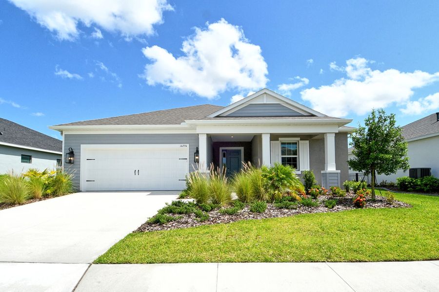 Front exterior of a new home in Canoe Creek, Parrish, FL, highlighting curb appeal (Image 1).