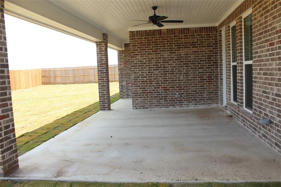 Fenced backyard with ceiling fan and a patio area Fenced backyard with ceiling fan and a patio area