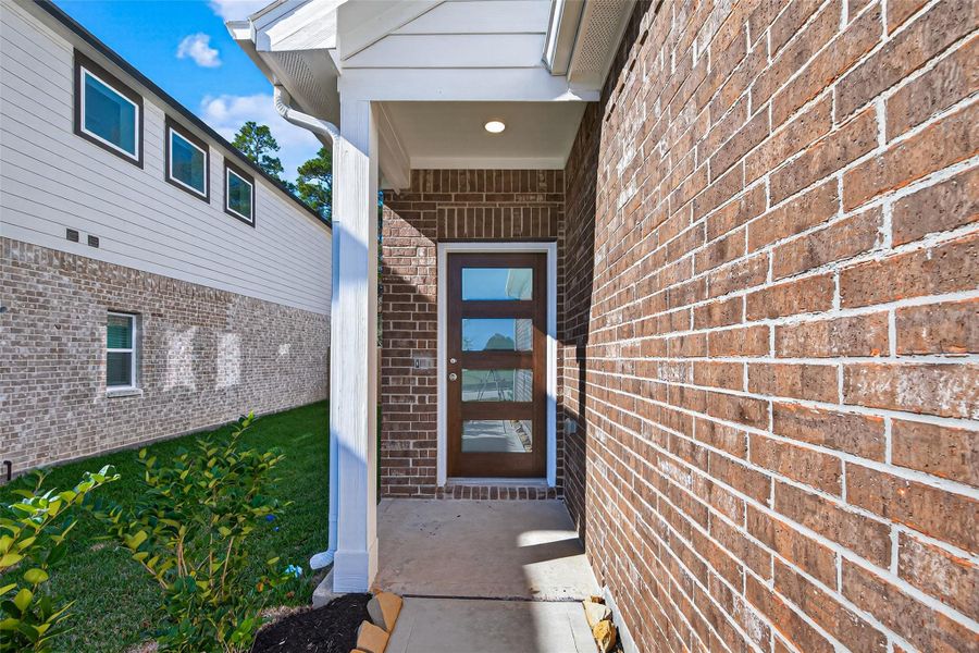 Exterior details and patio area of a home in Enclave at Willis, Willis (Image 3).