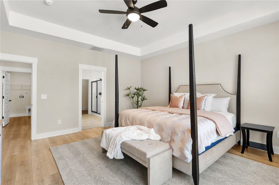This spacious primary bedroom offers comfort and d