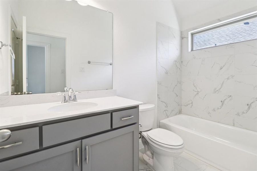 Full bath with vanity, shower / tub combination, and marble finish flooring Full bath with vanity, shower / tub combination, and marble finish flooring