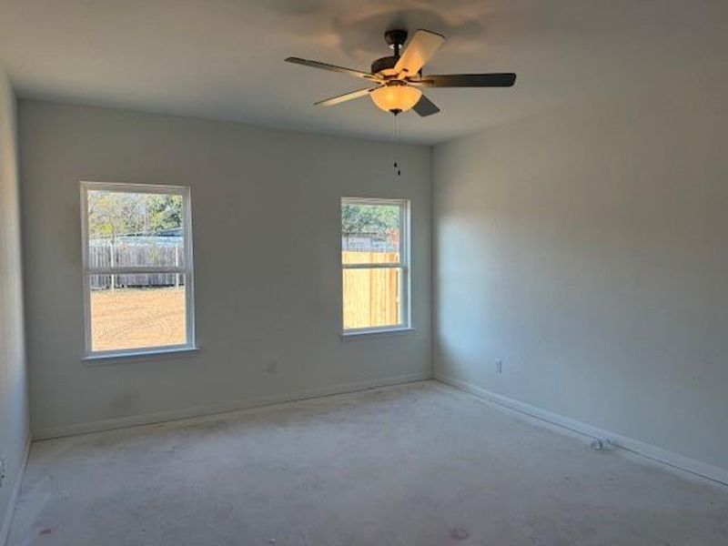 Spare room featuring baseboards and ceiling fan Spare room featuring baseboards and ceiling fan
