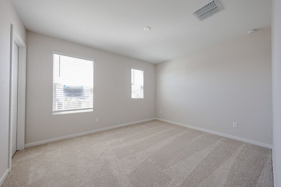 A room with a carpet and windows. A room with a carpet and windows.