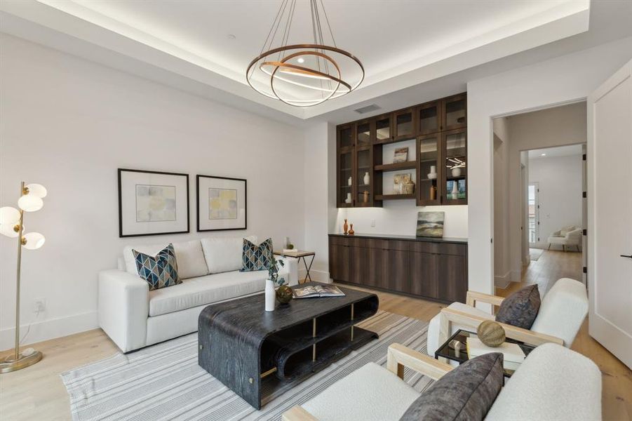 Office or flex room with white oak flooring, sliding iron & glass doors leading to courtyard, built-in cabinets and shelving, tray ceiling with lighting and designer lighting Office or flex room with white oak flooring, sliding iron & glass doors leading to courtyard, built-in cabinets and shelving, tray ceiling with lighting and designer lighting