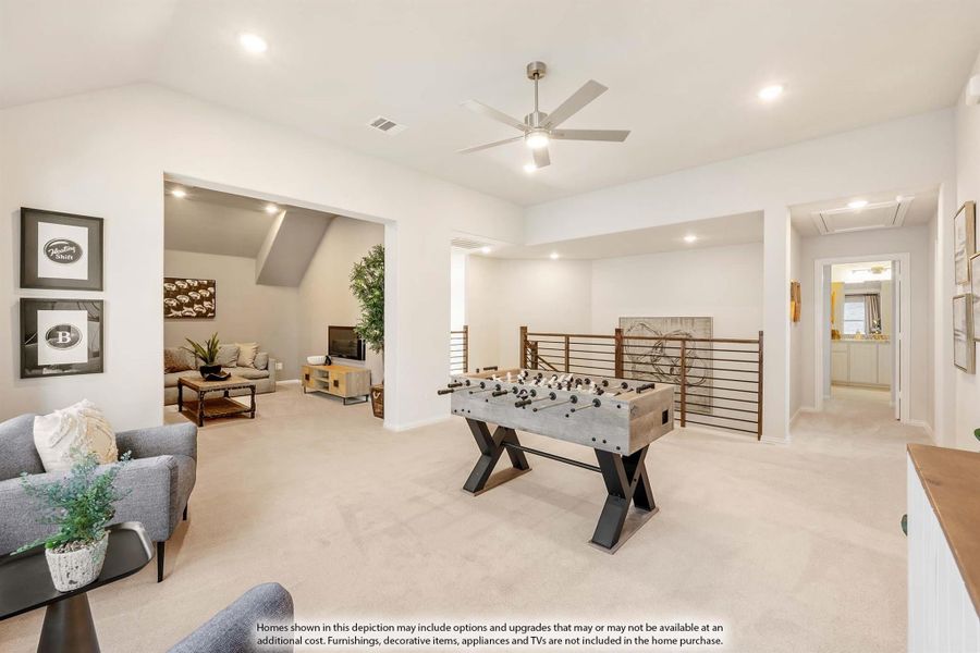 Upstairs game room with foosball table, ceiling fan, carpet flooring, and open railing overlooking lower level Upstairs game room with foosball table, ceiling fan, carpet flooring, and open railing overlooking lower level