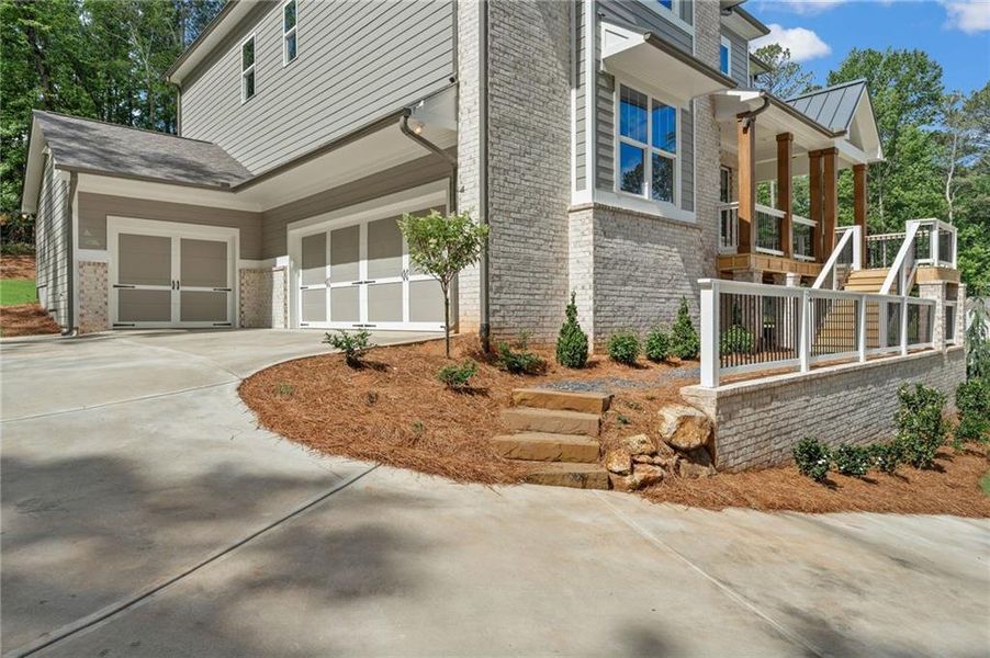 Front exterior of a new home in Liberty Springs, Woodstock, GA, highlighting curb appeal (Image 26). Front exterior of a new home in Liberty Springs, Woodstock, GA, highlighting curb appeal (Image 26).