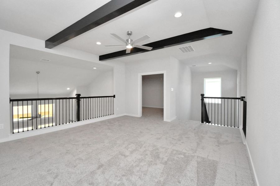 Come upstairs and enjoy a day of leisure in this fabulous game room! This is the perfect hangout spot or adult game room! Features plush carpet, high ceilings, custom paint and windows for plenty of natural light. Sample photo of completed home with similar floor plan. Actual colors and selections may vary.