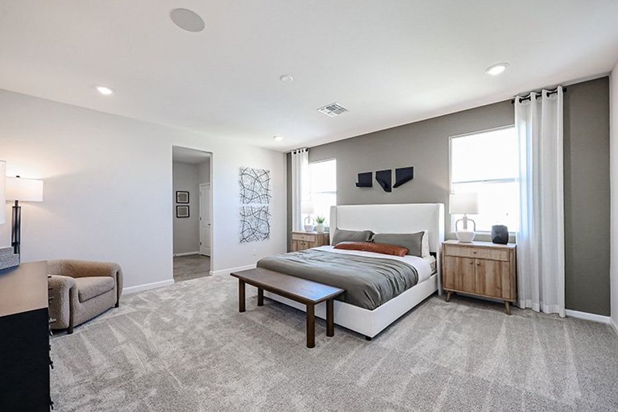 A bedroom with a bed and a bench. A bedroom with a bed and a bench.