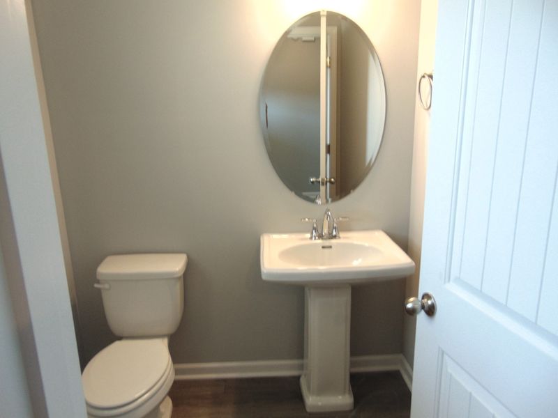 This powder room for all your guests, comes with a updated modern sink, and an elongated toilet for comfort.
