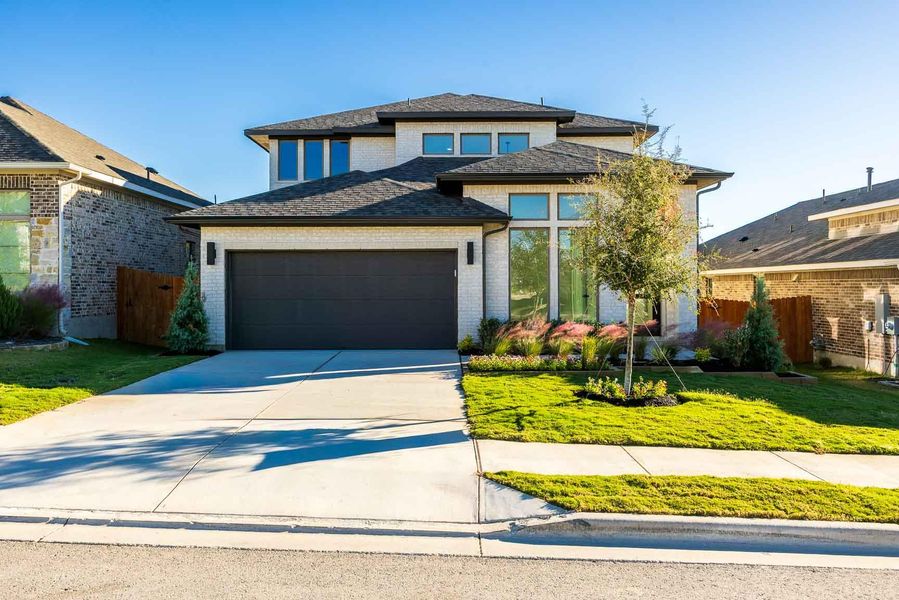 Front exterior of a new home in Lariat 50', Liberty Hill, TX, highlighting curb appeal (Image 1). Front exterior of a new home in Lariat 50', Liberty Hill, TX, highlighting curb appeal (Image 1).