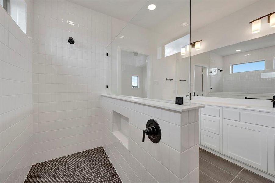 Bathroom with vanity, a walk in shower, and recessed lighting