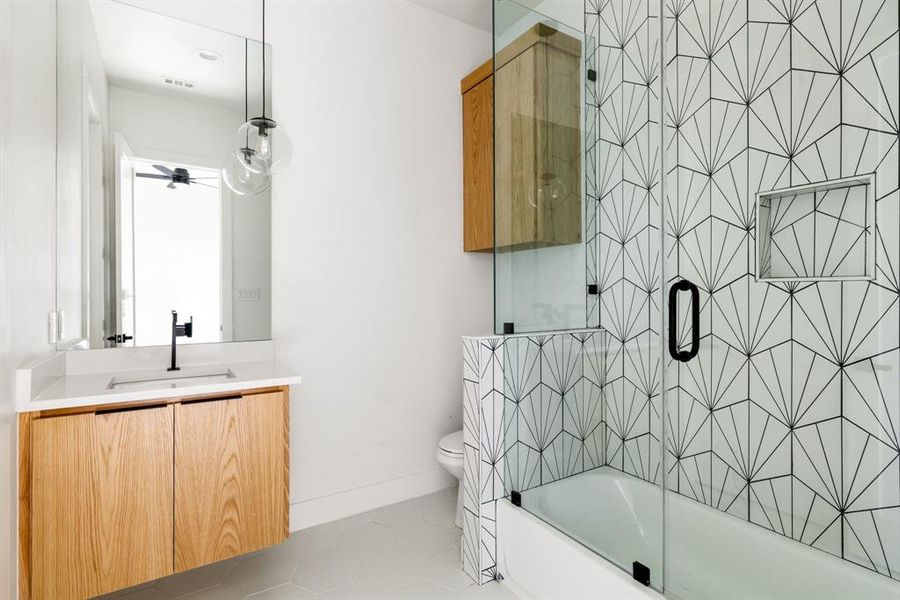 Bathroom with vanity, tile patterned floors, and enclosed tub / shower combo Bathroom with vanity, tile patterned floors, and enclosed tub / shower combo