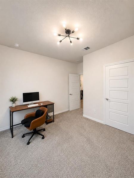 Neutral-toned carpeting enhances this versatile room, featuring a modern sputnik-style ceiling light fixture