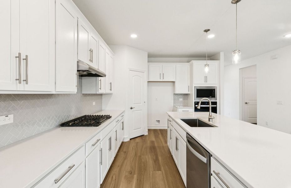 High-end gourmet kitchen with premium finishes and upgraded appliances  *Real home pictured