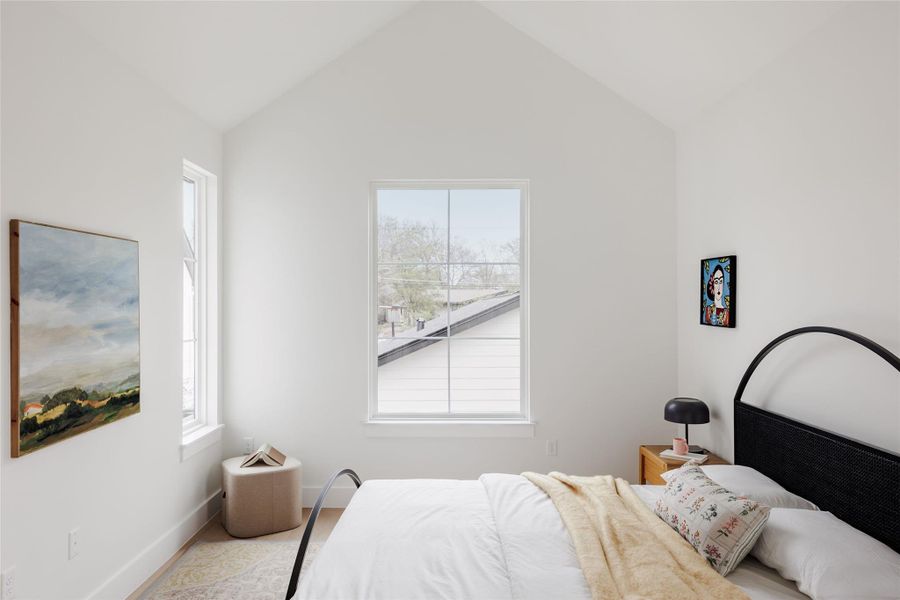 Bedroom with light wood-type flooring and baseboards