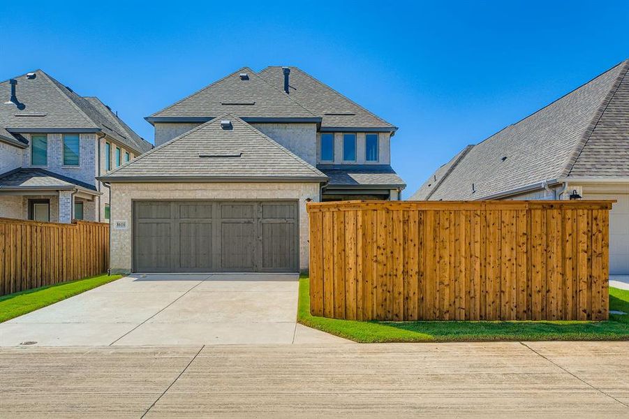 French country inspired facade with driveway, a garage, stucco siding, and a shingled roof French country inspired facade with driveway, a garage, stucco siding, and a shingled roof