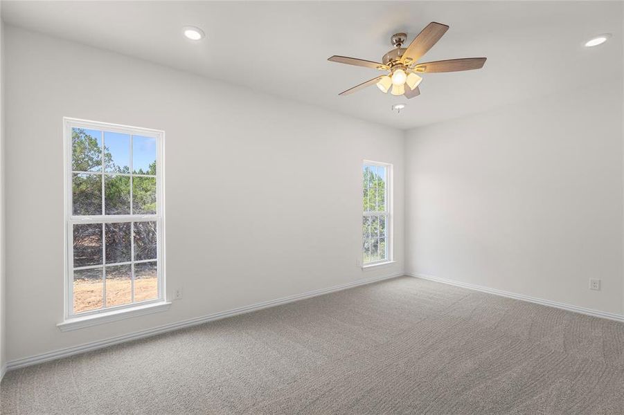 Empty room featuring carpet floors, recessed lighting, and a ceiling fan