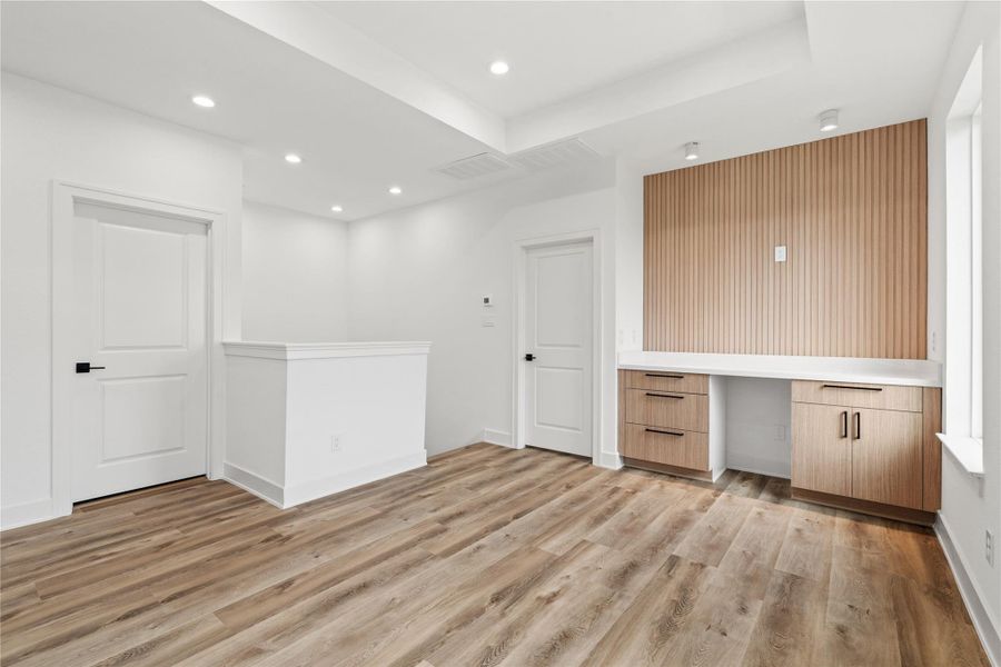 Sleek powder bath with a modern vanity, bold black fixtures, and great natural light.