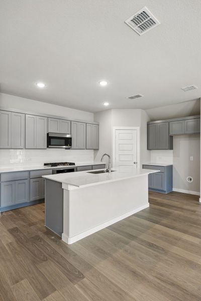 Kitchen in the Emmy II home plan by Trophy Signature Homes - REPRESENTATIVE PHOTO