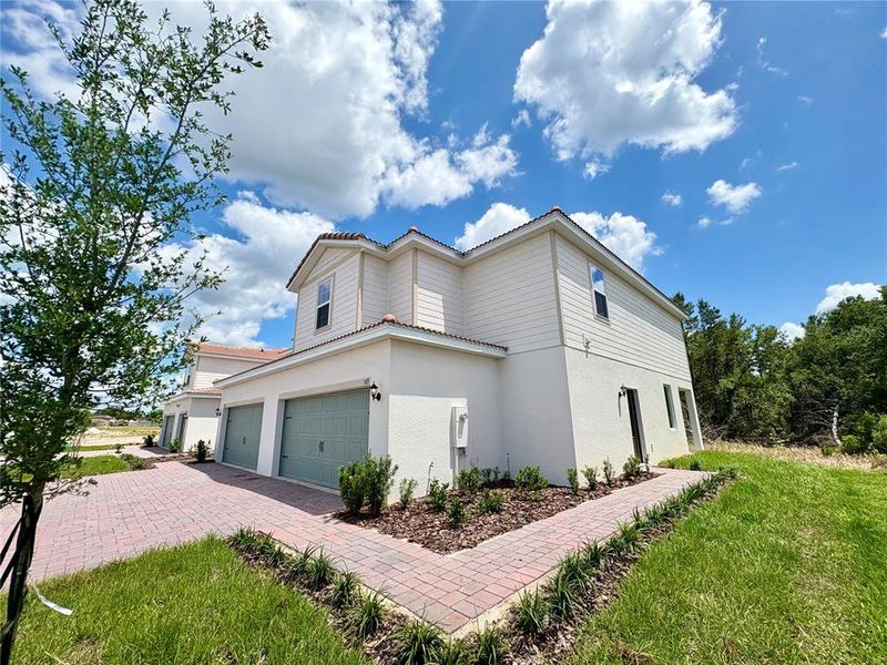 Front exterior of a new home in , Poinciana, FL, highlighting curb appeal (Image 2). Front exterior of a new home in , Poinciana, FL, highlighting curb appeal (Image 2).