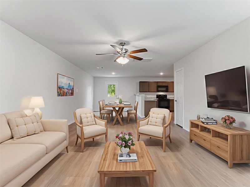 Virtually staged living area open to the dining and kitchen area