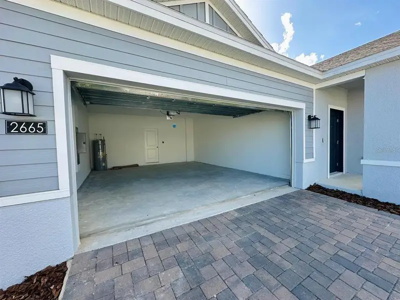 Exterior details and patio area of a home in Wellness Ridge: Estates Collection, Clermont (Image 2).