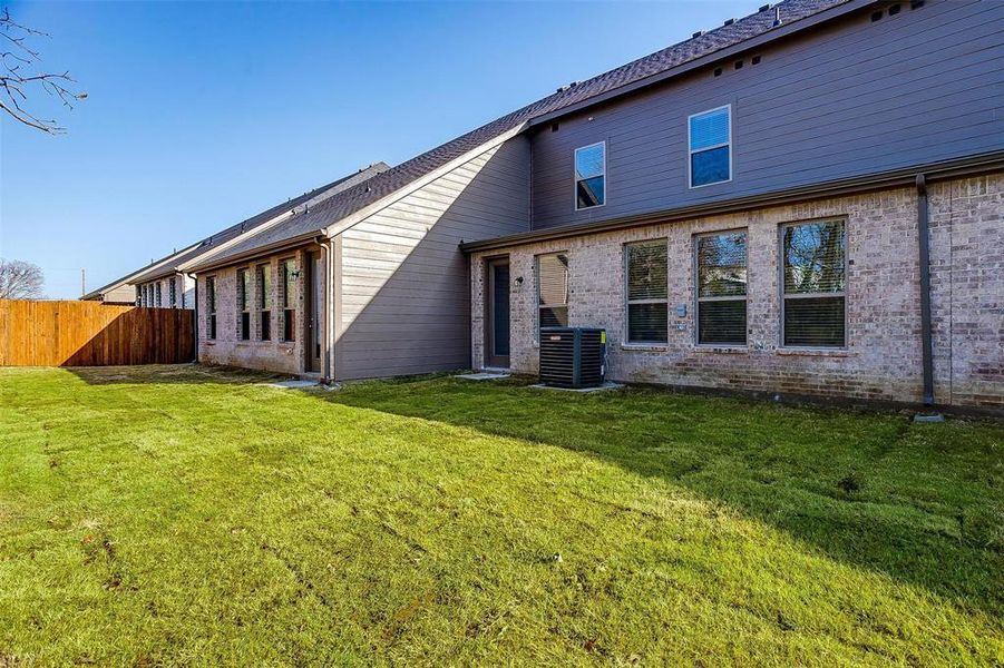 Rear view of house featuring brick siding