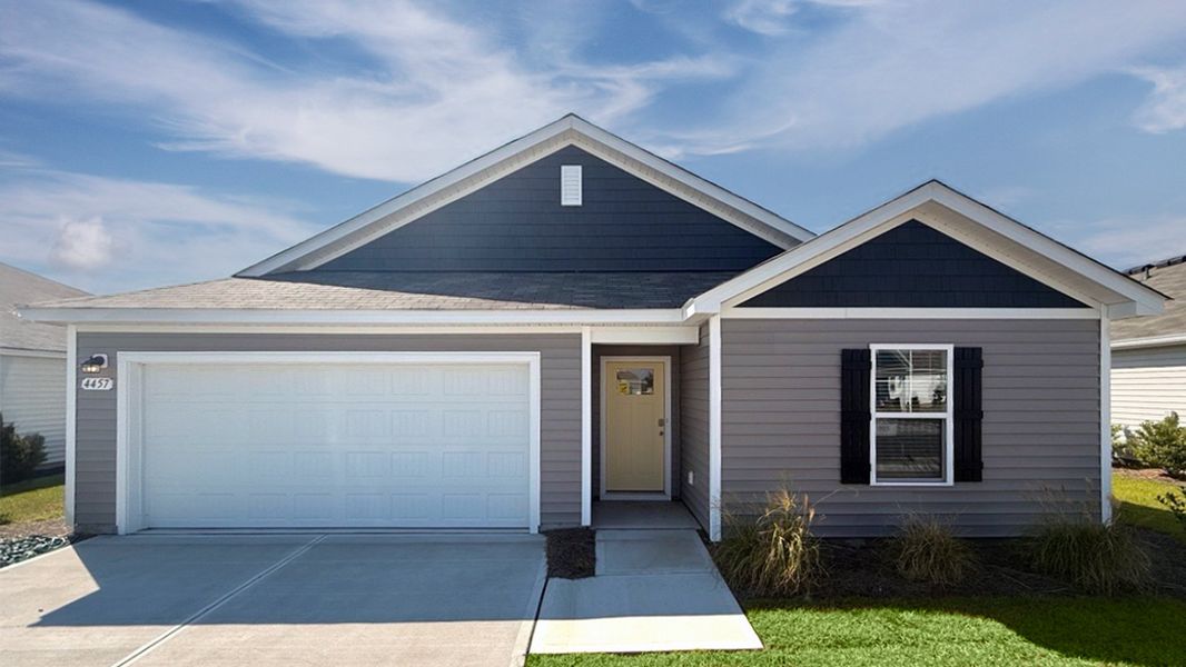 Front exterior of a new home in The Meadows at Wildwood Village, Shallotte, NC, highlighting curb appeal (Image 1). Front exterior of a new home in The Meadows at Wildwood Village, Shallotte, NC, highlighting curb appeal (Image 1).