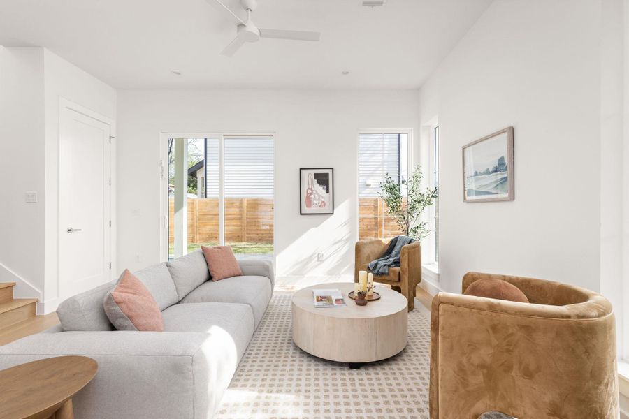 Living room with ceiling fan and stairway Living room with ceiling fan and stairway
