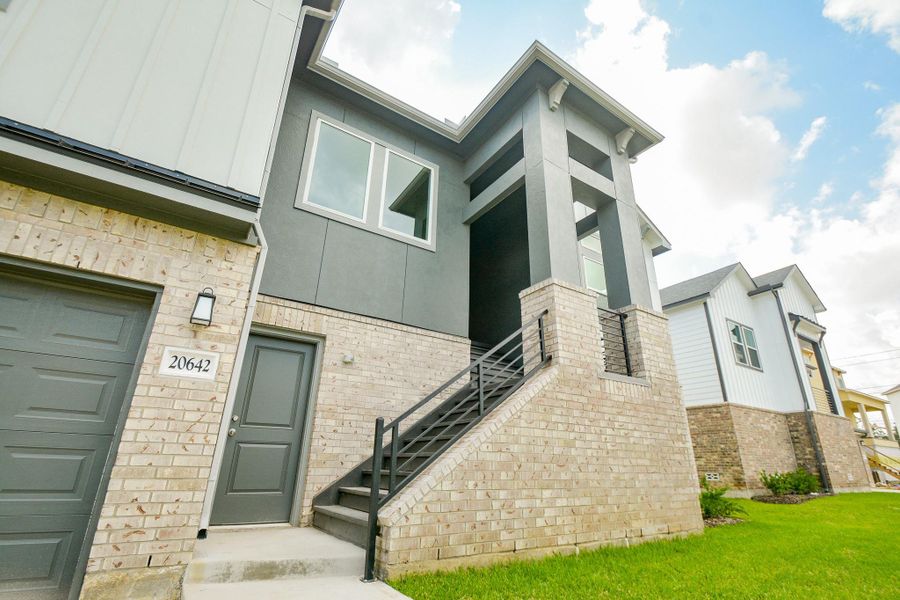Discover the stairs that ascend to a covered porch and the front door.