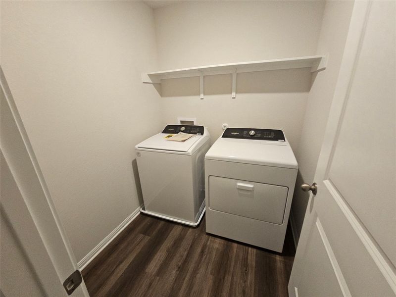 Laundry room with dark wood-style flooring and washer and dryer Laundry room with dark wood-style flooring and washer and dryer