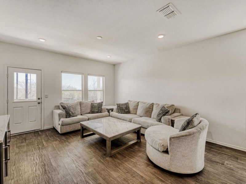 Living room featuring dark wood-style floors