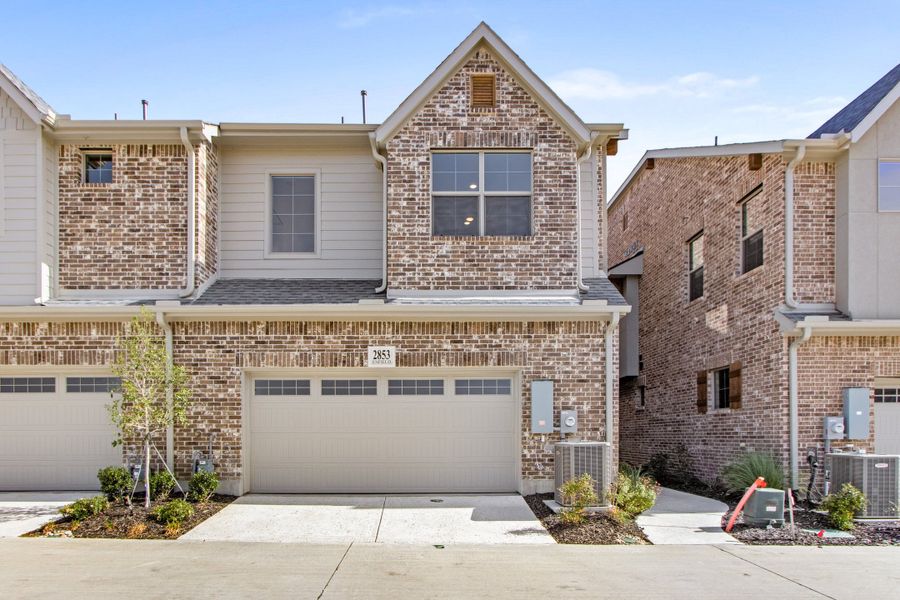 Front exterior of a new home in The Tribute, The Colony, TX, highlighting curb appeal (Image 26). Front exterior of a new home in The Tribute, The Colony, TX, highlighting curb appeal (Image 26).