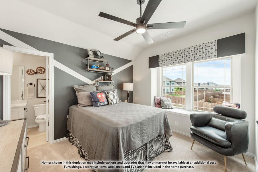 Bedroom with vaulted ceiling, gray accent wall, ceiling fan, and ensuite bathroom access