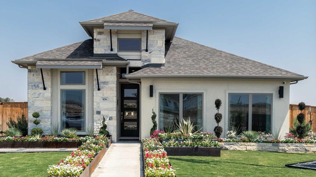View of front of property with stone siding, a shingled roof, and stucco siding