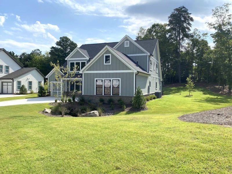 Front exterior of a new home in Arden on Lanier, Cumming, GA, highlighting curb appeal (Image 2). Front exterior of a new home in Arden on Lanier, Cumming, GA, highlighting curb appeal (Image 2).