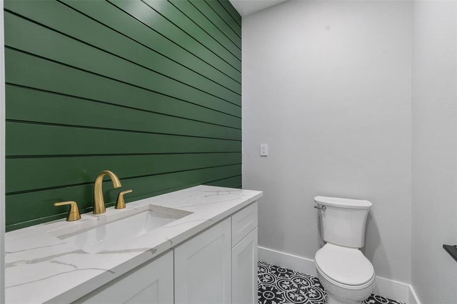 Bathroom featuring vanity, toilet, and tile patterned floors