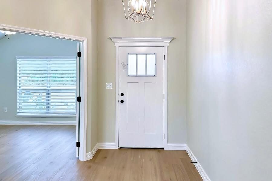 Foyer entrance featuring light wood-style floors and a chandelier
