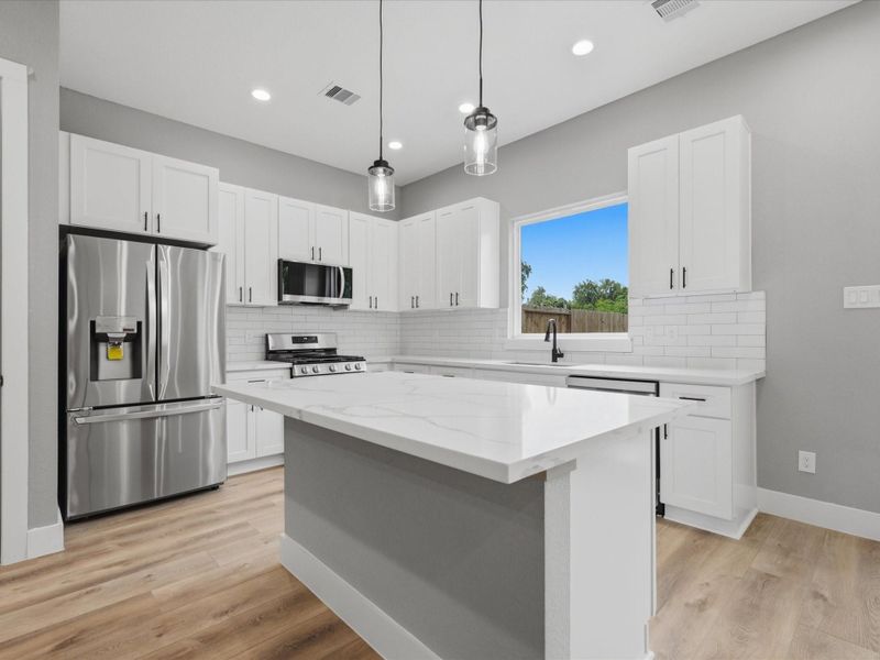 Quartz countertops, 42" shaker-style cabinetry, and stainless steel built-in appliances bring both style and functionality to the kitchen. Quartz countertops, 42" shaker-style cabinetry, and stainless steel built-in appliances bring both style and functionality to the kitchen.