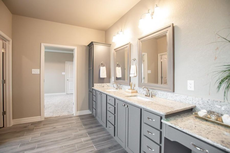 Bathroom featuring wood finished floors and double vanity Bathroom featuring wood finished floors and double vanity