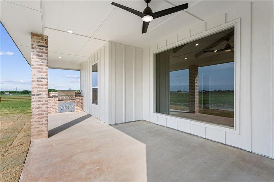 View of patio featuring ceiling fan, exterior kitchen, and a grill