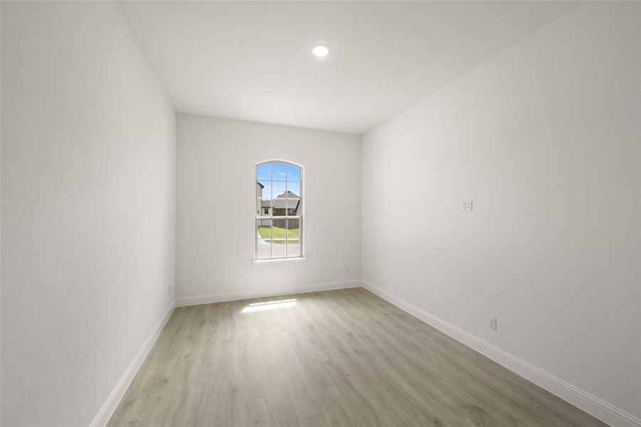 Empty room with light wood finished floors and recessed lighting Empty room with light wood finished floors and recessed lighting