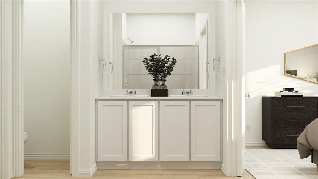 Bathroom featuring double vanity, wood-type flooring, and toilet