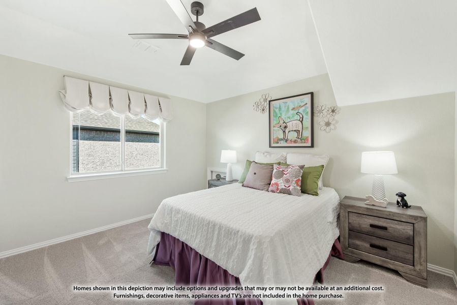Bedroom with vaulted ceiling, ceiling fan, carpet flooring, and queen bed with colorful pillows and wood nightstands Bedroom with vaulted ceiling, ceiling fan, carpet flooring, and queen bed with colorful pillows and wood nightstands