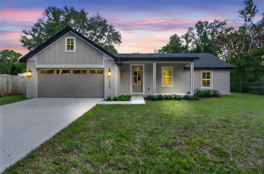 Front exterior of a new home in , Orange City, FL, highlighting curb appeal (Image 1). Front exterior of a new home in , Orange City, FL, highlighting curb appeal (Image 1).