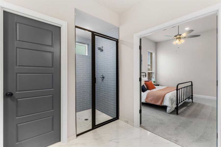 Bathroom featuring a shower with door, tile patterned flooring, and ceiling fan