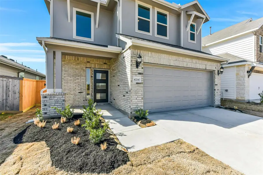Front exterior of a new home in Colony at Pinehurst, Pinehurst, TX, highlighting curb appeal (Image 2). Front exterior of a new home in Colony at Pinehurst, Pinehurst, TX, highlighting curb appeal (Image 2).