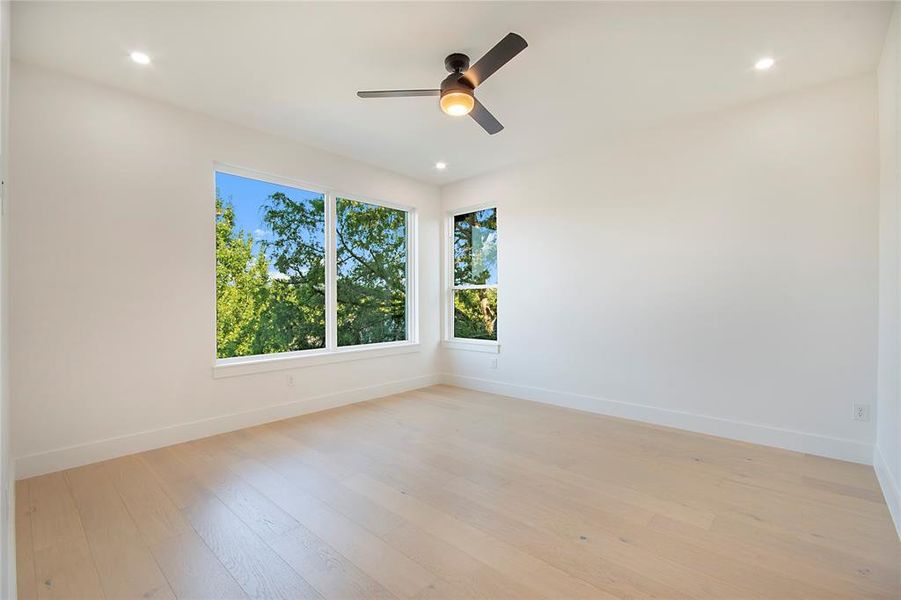 Empty room featuring light wood-style flooring, recessed lighting, and ceiling fan Empty room featuring light wood-style flooring, recessed lighting, and ceiling fan