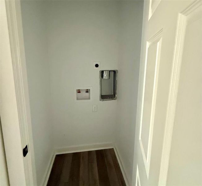Laundry room featuring dark wood-type flooring and hookup for a washing machine