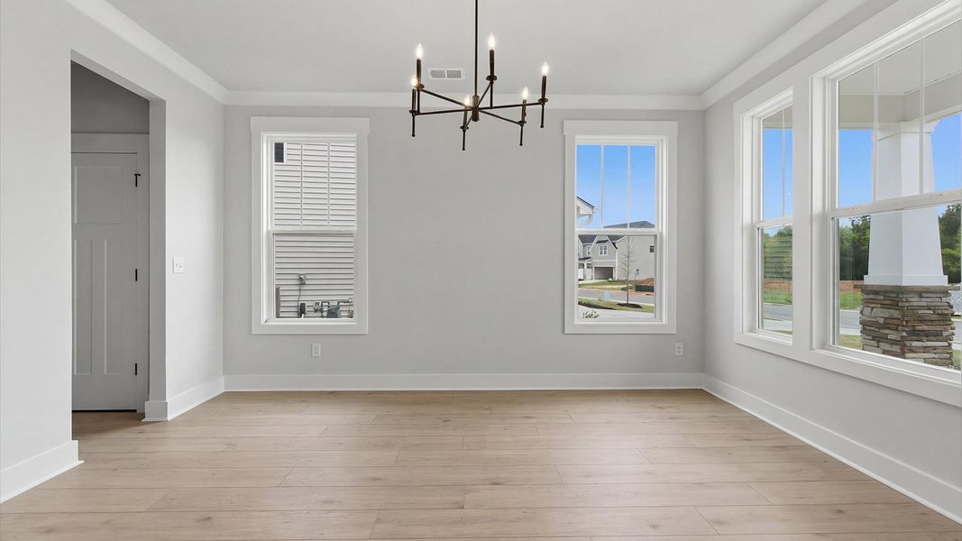 Elegant dining room with tasteful finishes in this prime Foxbank single family home by DRB Homes